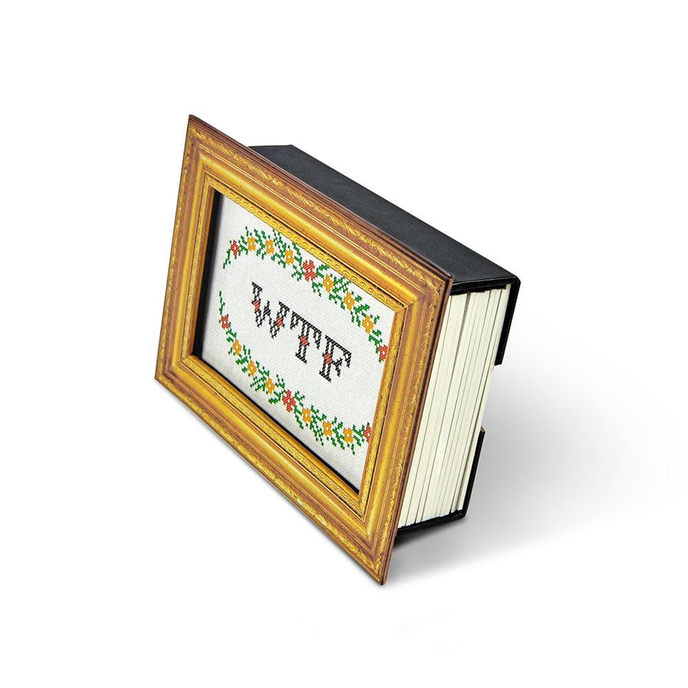 side view of gold frame holding all cards with "WTF" on the front.