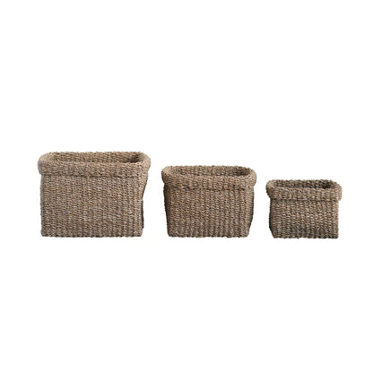 all three sizes of woven seagrass baskets on a white background