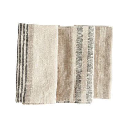 three folded woven cotton striped napkins on a white background