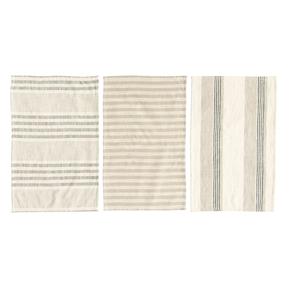 all three styles of woven cotton striped tea towels laid out on a white surface
