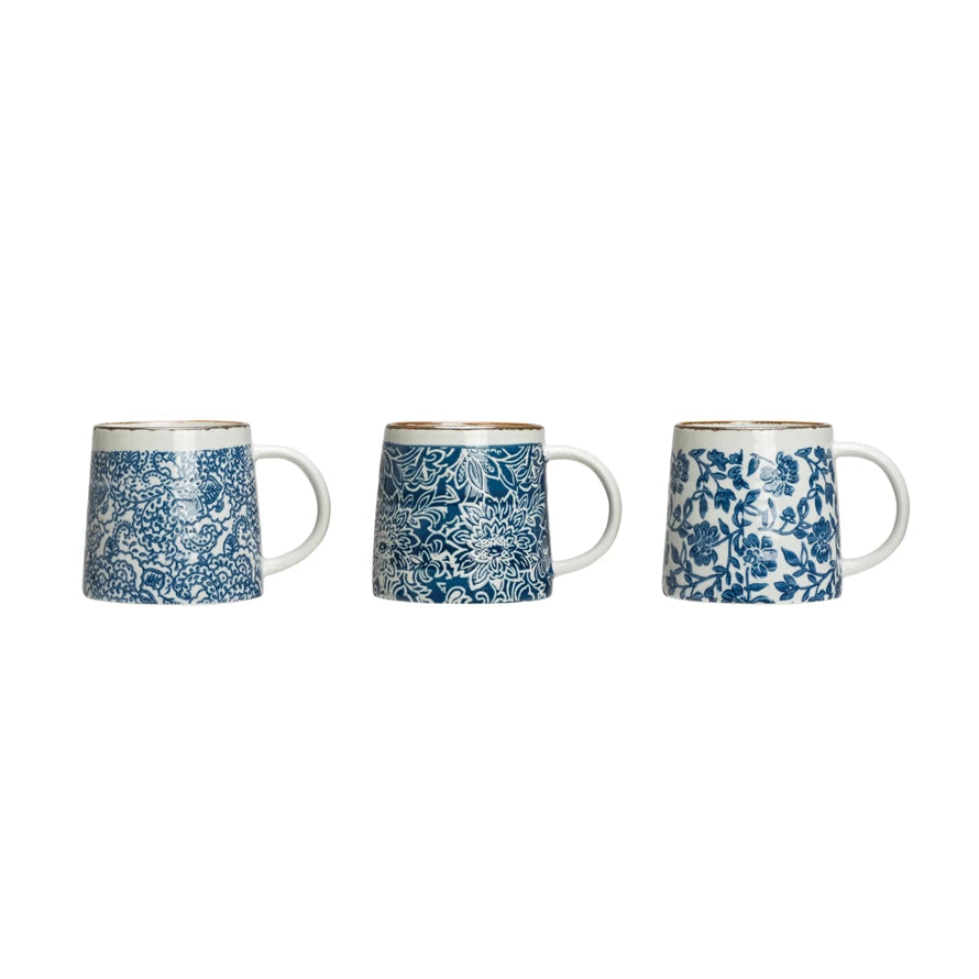 3 mugs with blue floral patterns in a row on a white background.