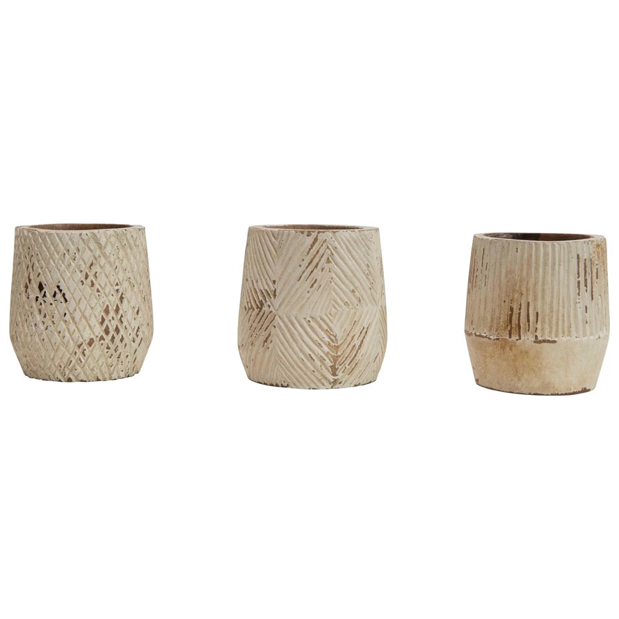 3 wooden pots in a row on a white background.