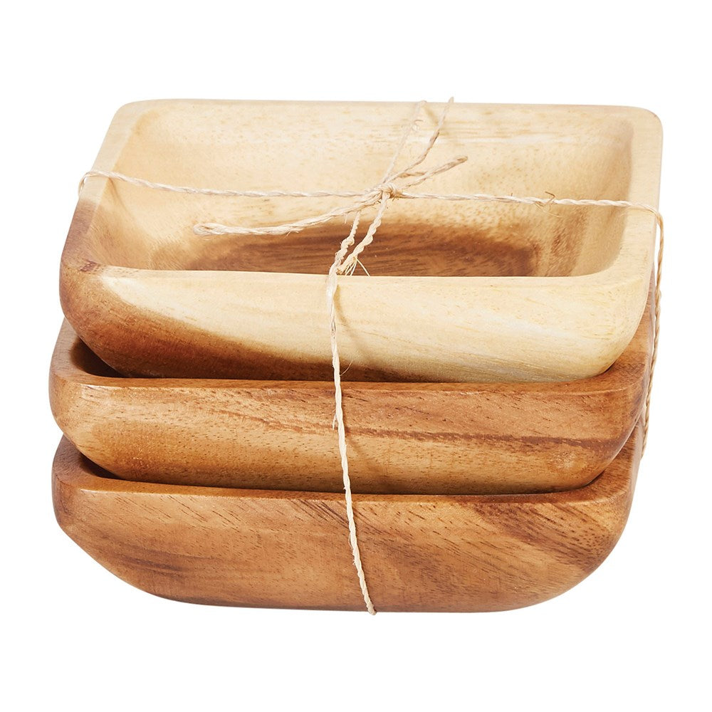 three stacked square acacia wood bowls and tied with twine against a white background