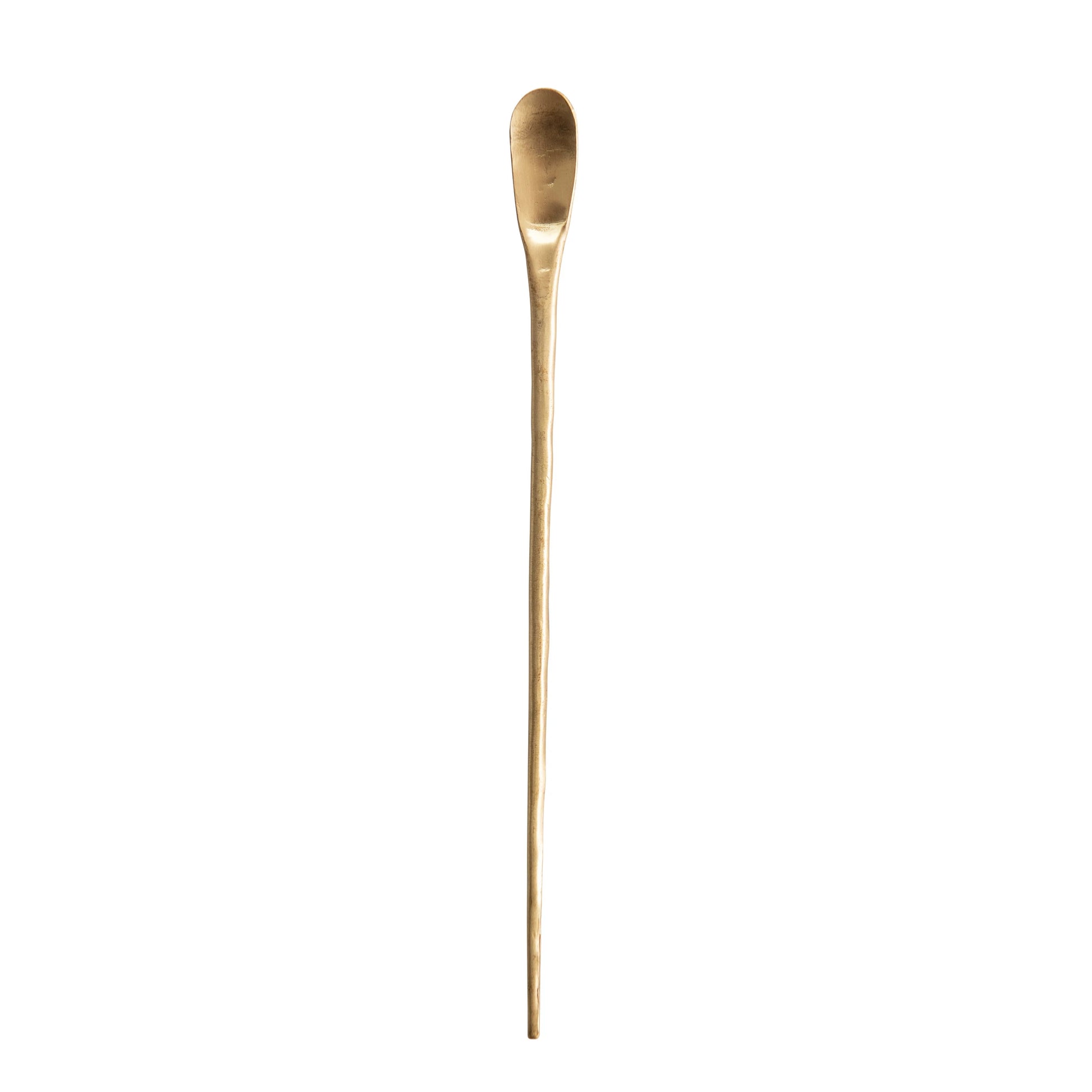 brass cocktail spoon on a white background