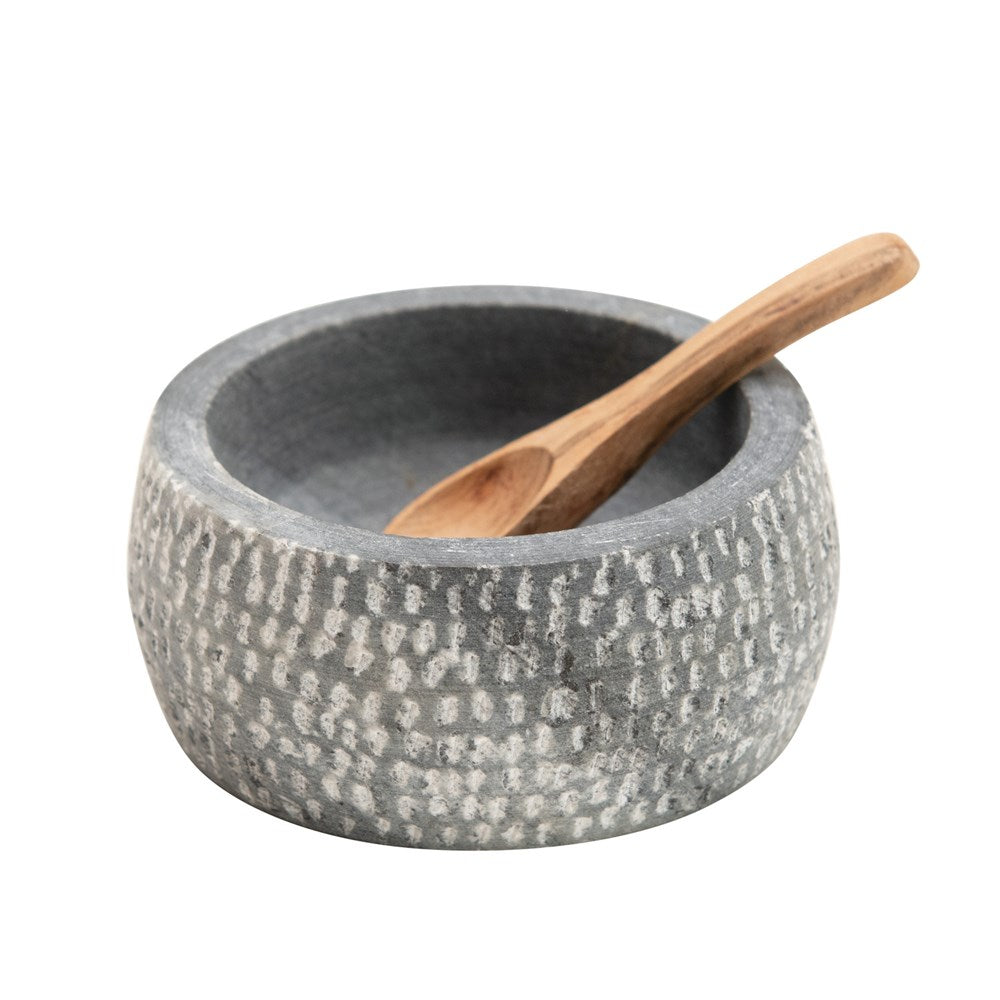 grey granite bowl with wooden spoon in it on a white background.