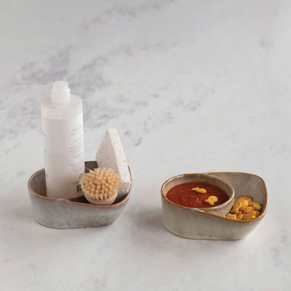 cream stoneware cracker and soup bowl displayed with cleaning brush and soap and taupe with gold fish and soup on a white background