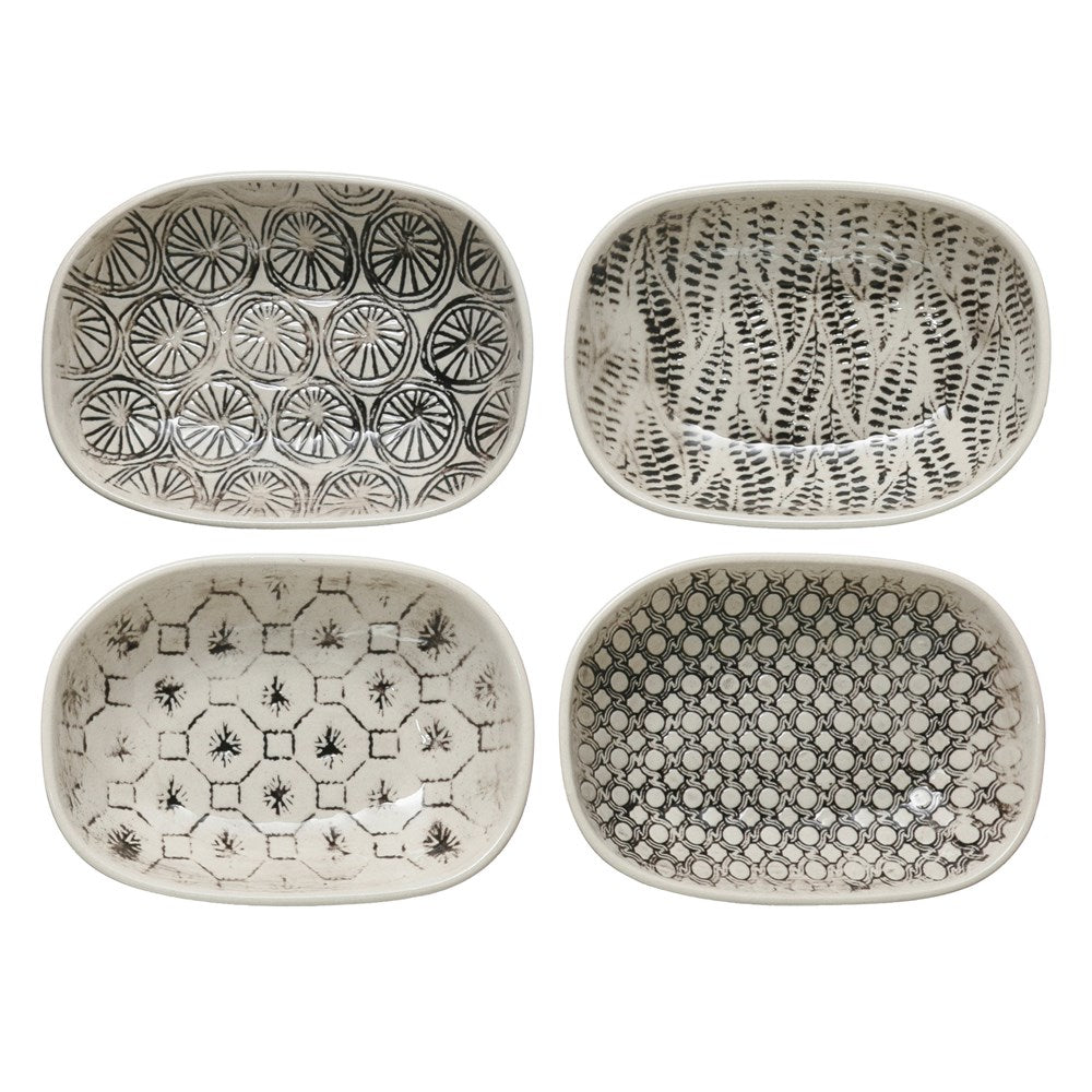 all four patterns of hand stamped stoneware dishes are white with black patterns displayed on a white background