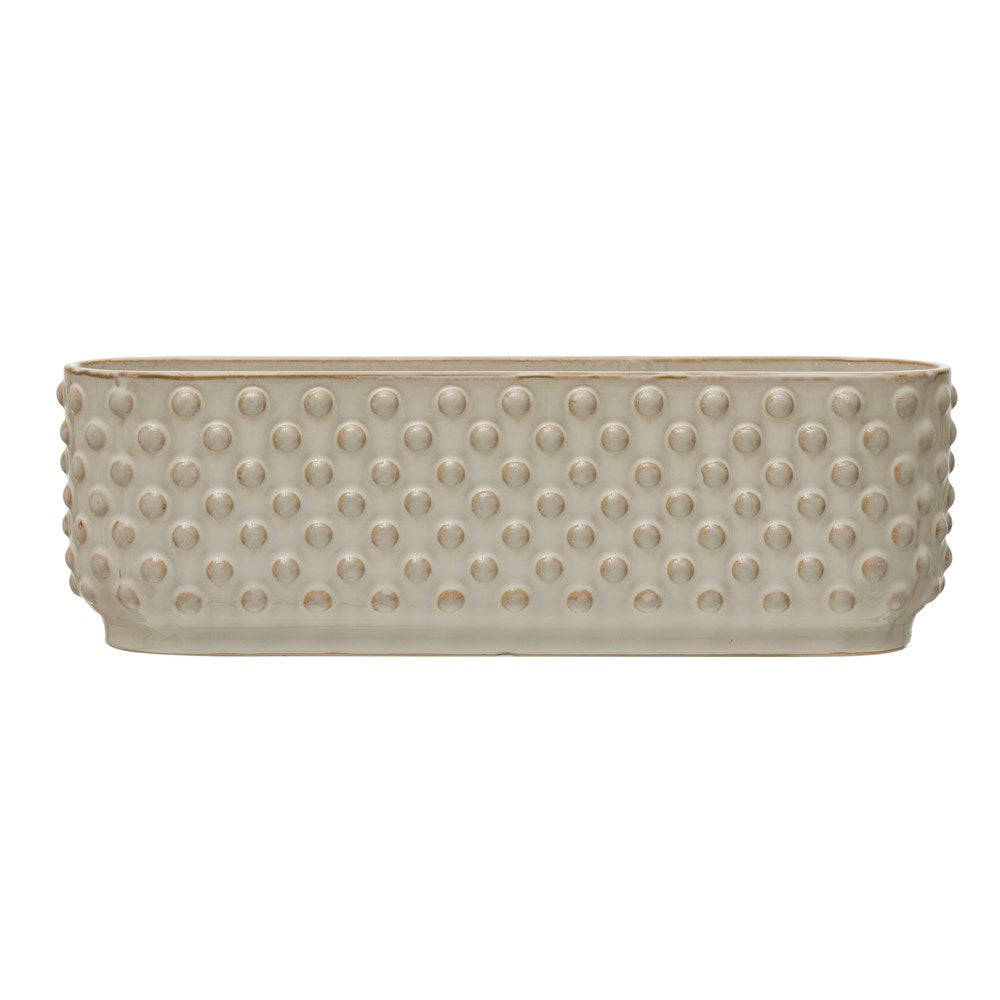 Side view of white three section planter with dotted design.