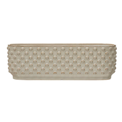Side view of white three section planter with dotted design.