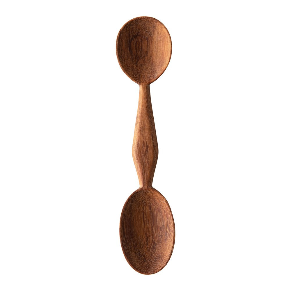 hand carved two sided doussie wood spoon on a white background