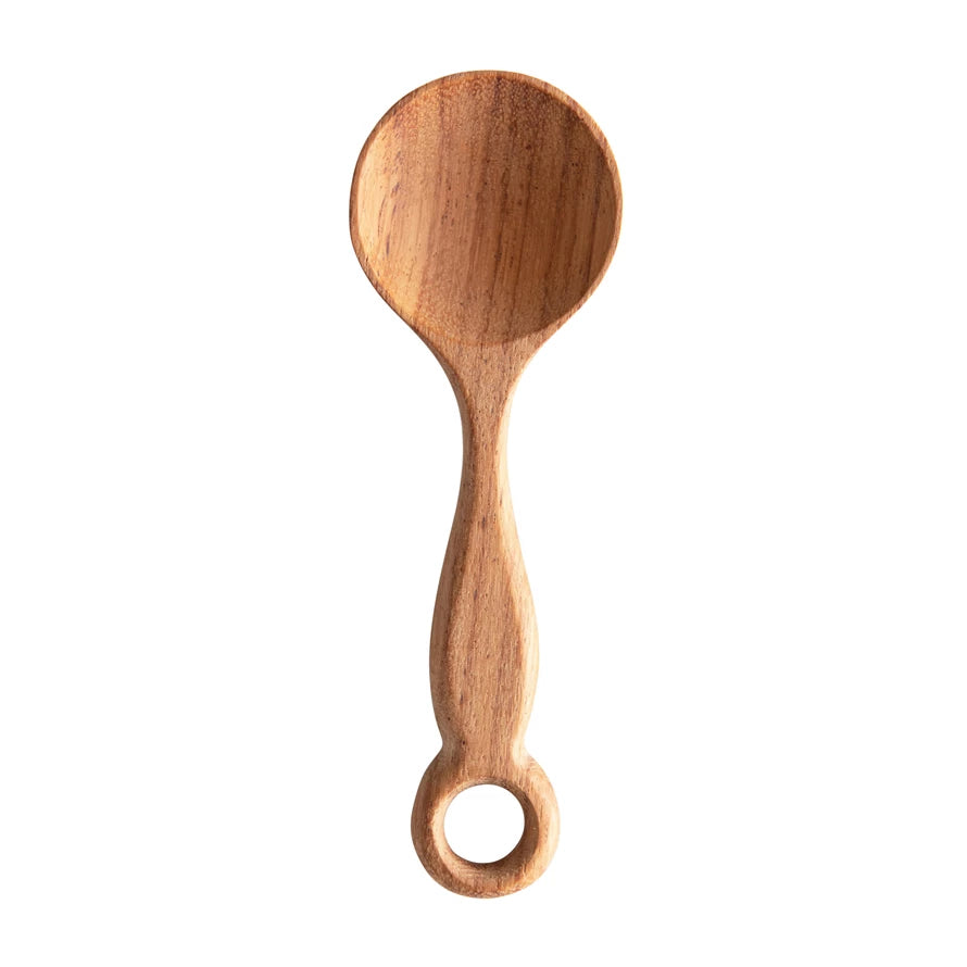 wide carved doussie spoon on a white background