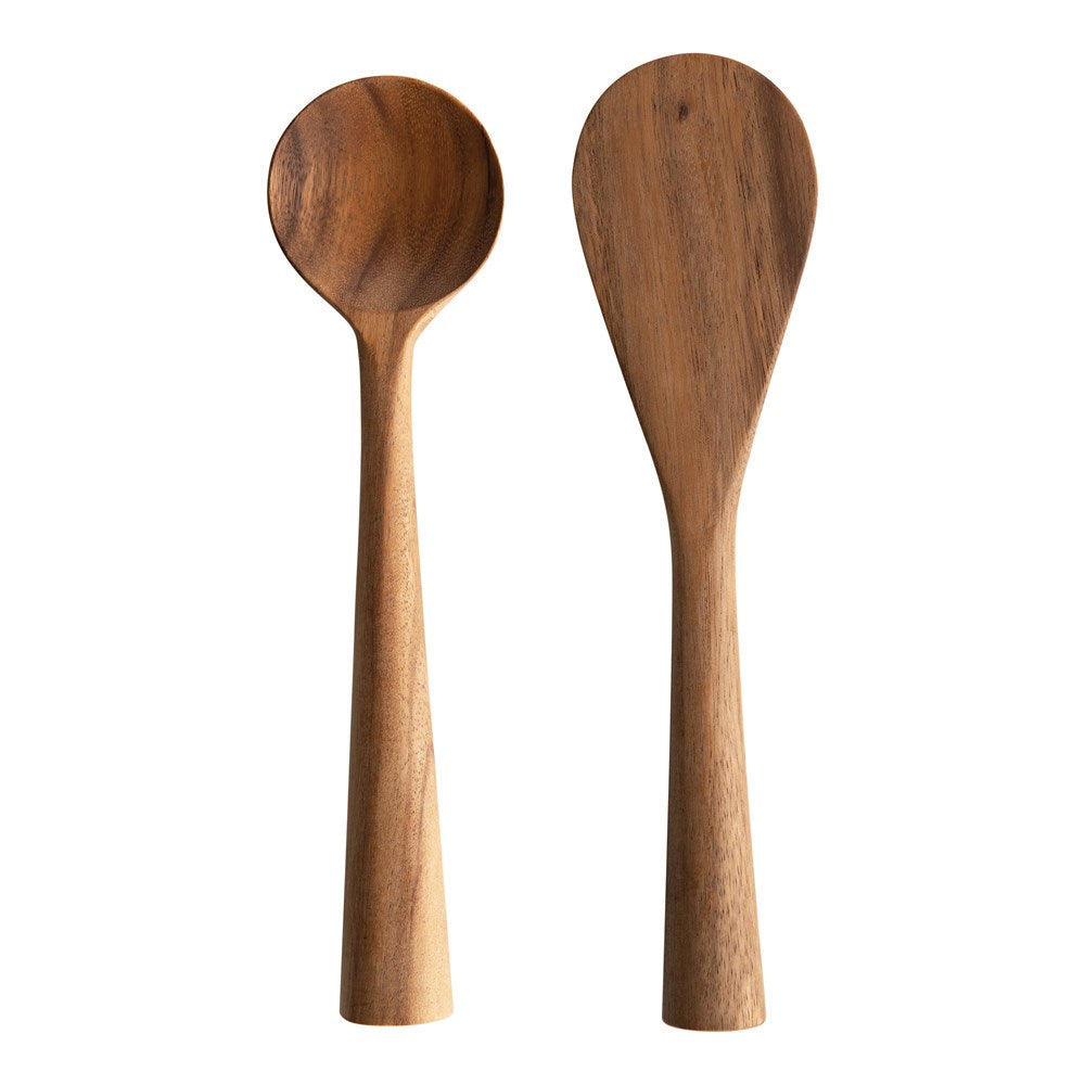 hand carved acacia wood standing spoons on a white background