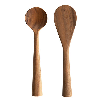 hand carved acacia wood standing spoons on a white background