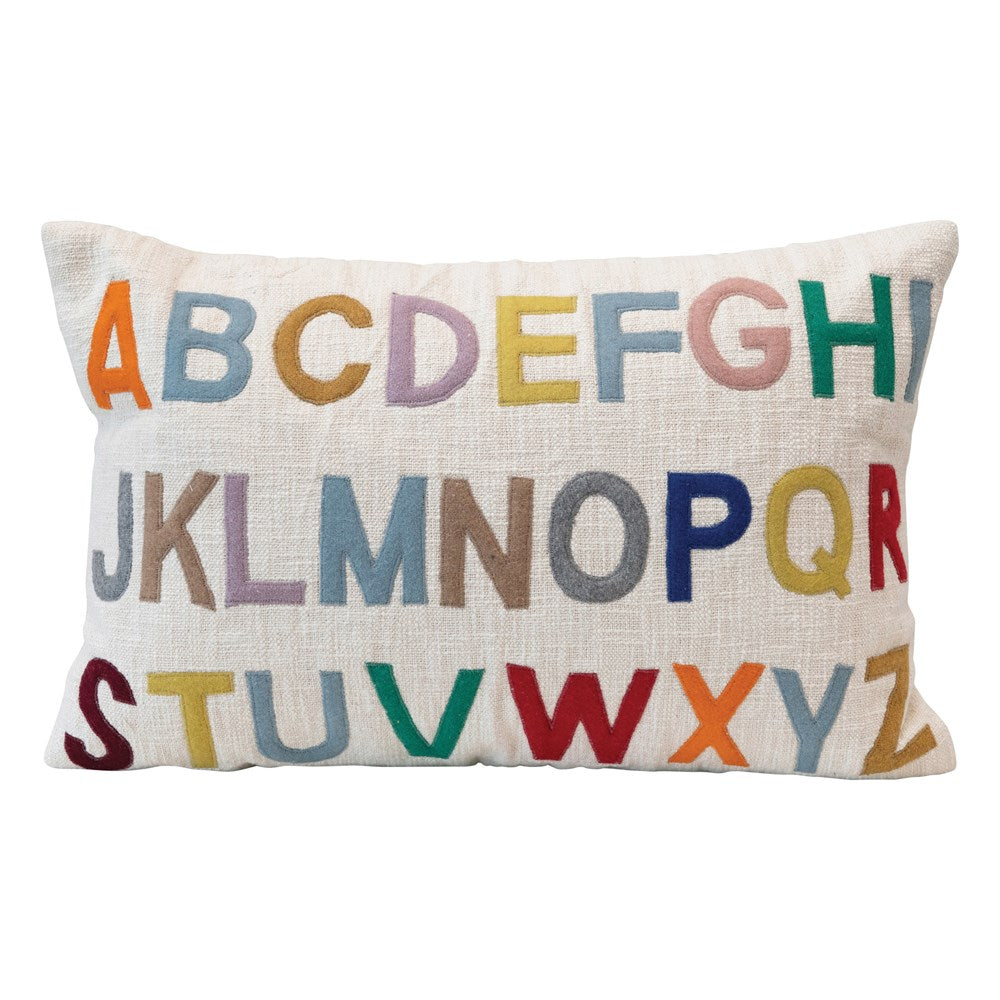 alphabet pillow is filled with multi colored letters against a white background