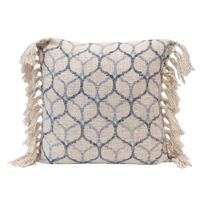 patterned pillow with tassels on a white background