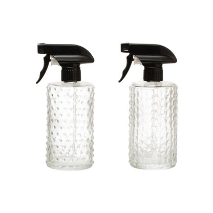 two glass spray bottles on a white background