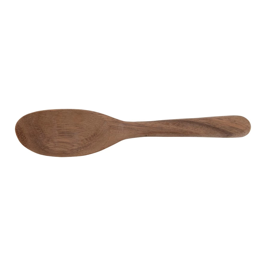 hand carved acacia wood spoon on a white background