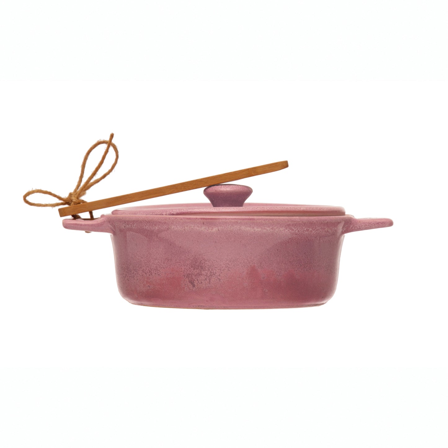 side view of a pink brie baker with wooden spreader tied to the handle on a white background.