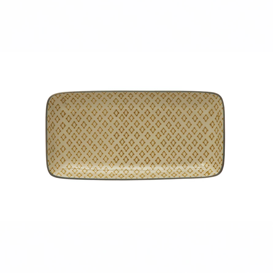 rectangle platter with dark ivory glaze and mustard geometric pattern ahown on a white background.