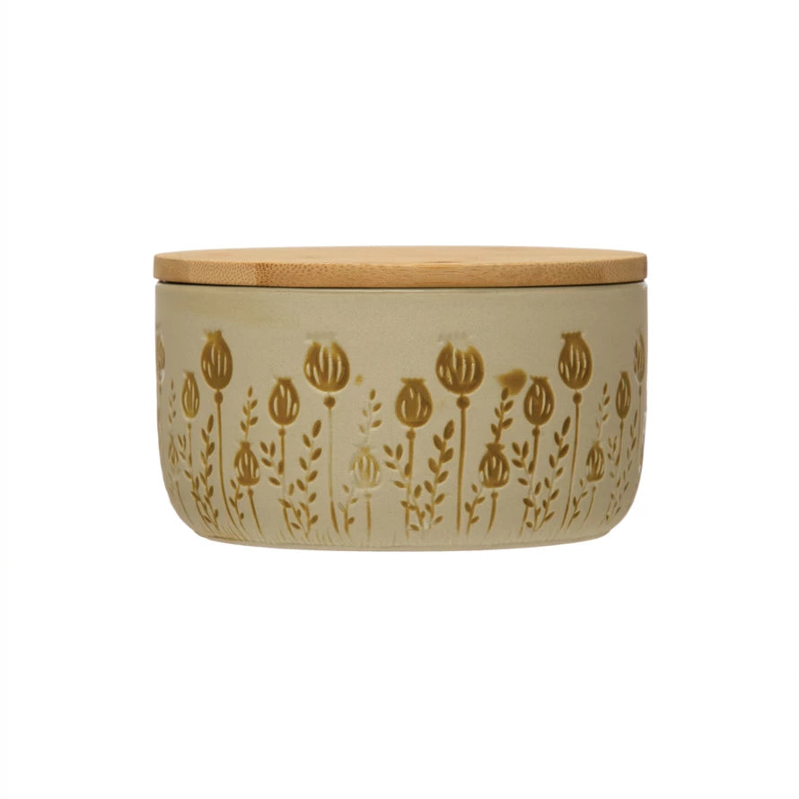 off-white canister with simple mustard color floral design around it.