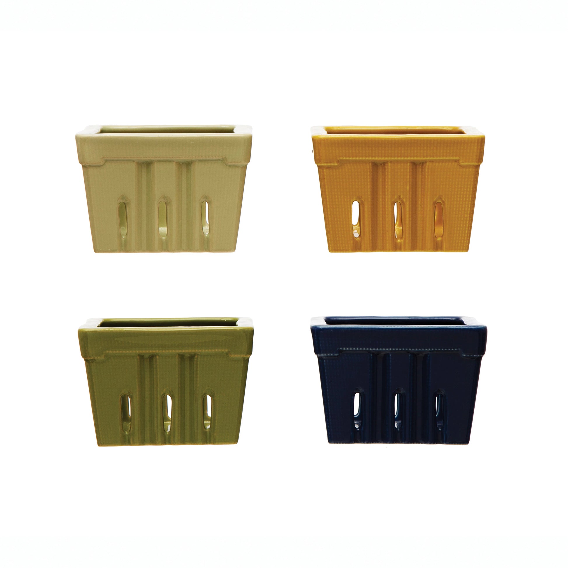 four different colors of textured stoneware berry baskets on a white background