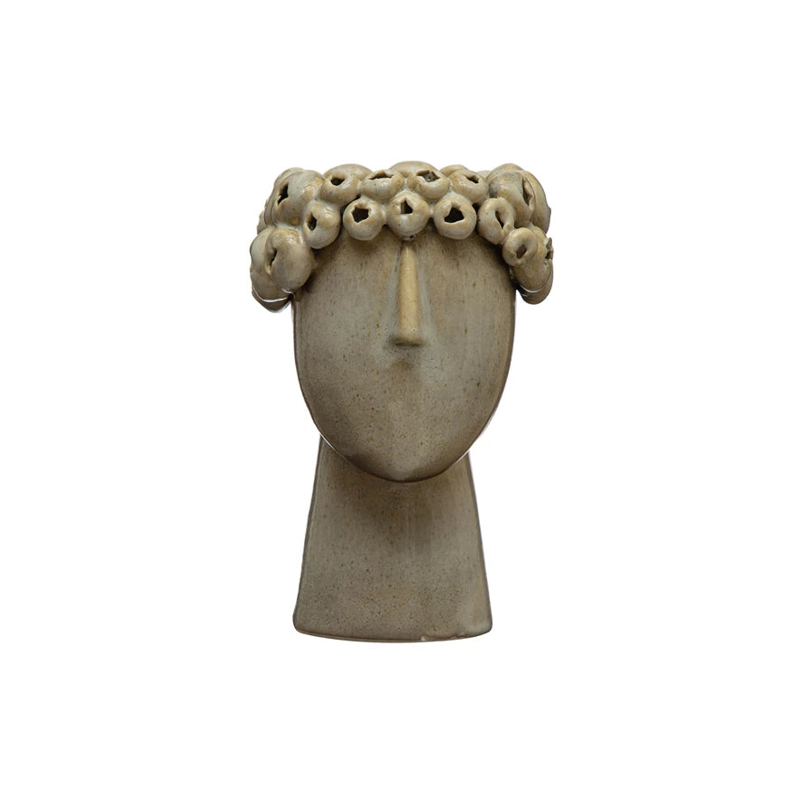 head planter with slim neck and nose and circular pieces creating a simple head wreath around the top opening.