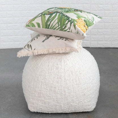 large white puff with 2 pillows stacked on top.