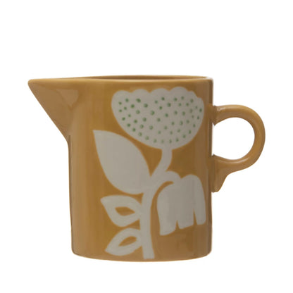 mustard yellow ceramic creamer with Scandinavian floral design.