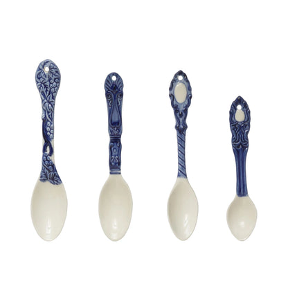 assorted blue and white spoons on white background.