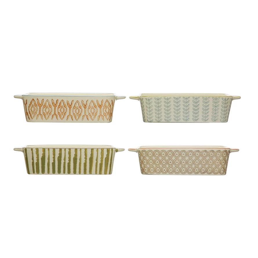 4 assorted baking dishes on a white background.