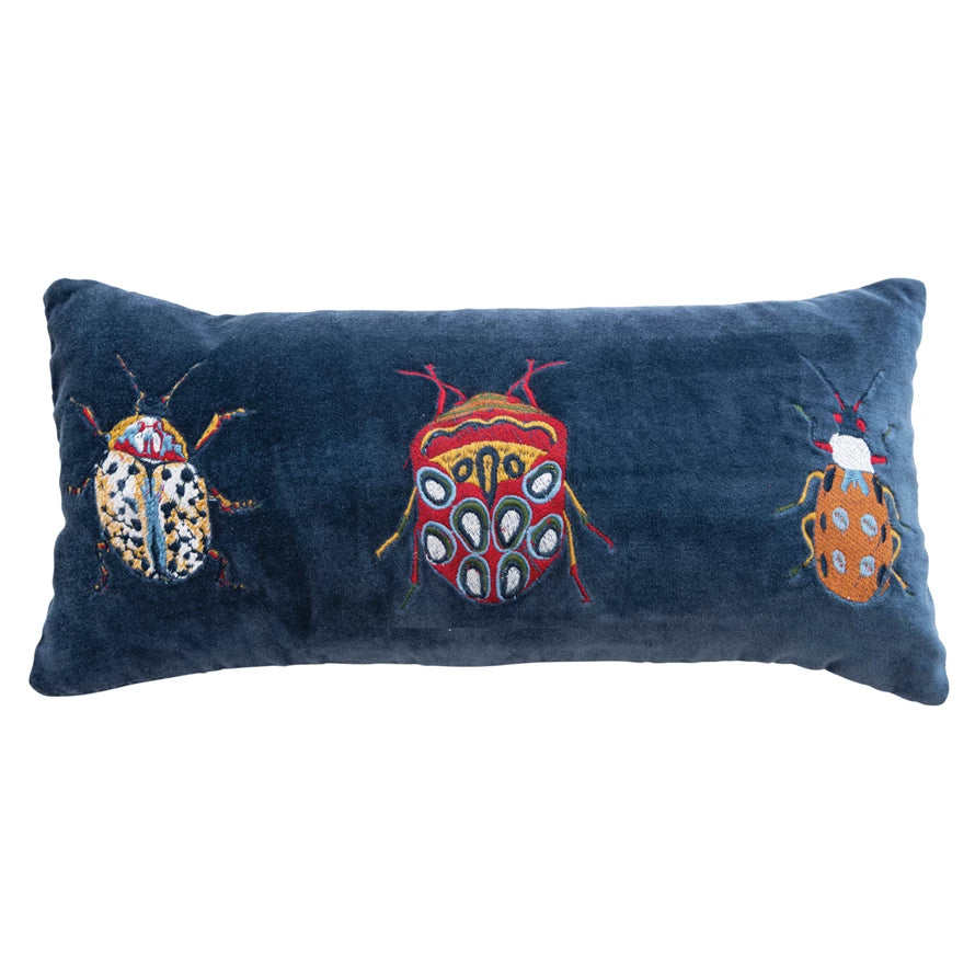 blue velvet embroidered lumbar pillow with three unique beetles on a white background