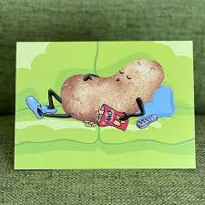 the front of card has a potato dressed like a human  resting on a couch