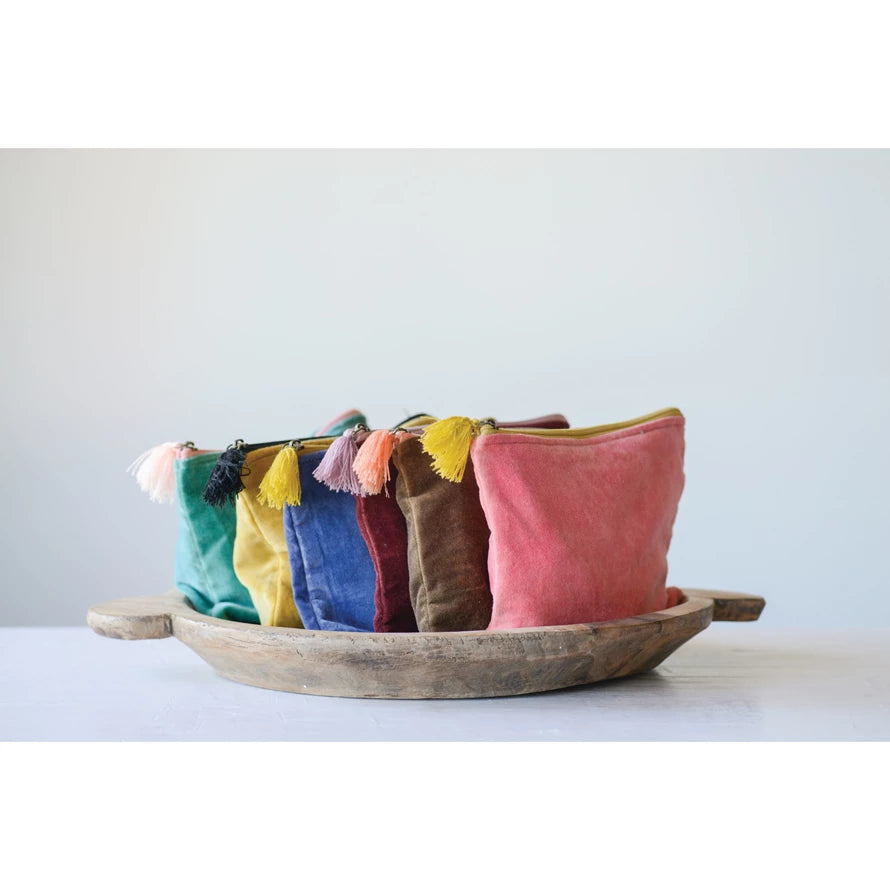 all six colors of velvet zip pouch with tassels displayed in a rustic wooden bowl against a white background