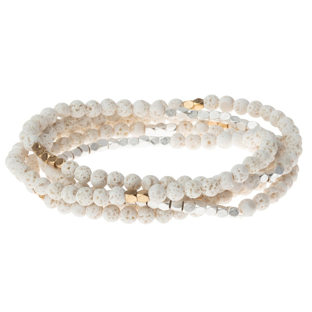 4.5 millimeter white lava beads interspersed with golden beads wrapped four times to form a bracelet, shown on a white background.