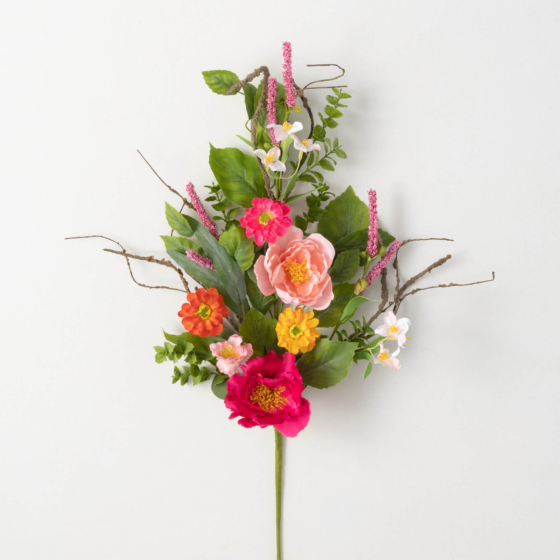 collection of artificial flowers in shades of pink, yellow, and orange with assorted green leaves.