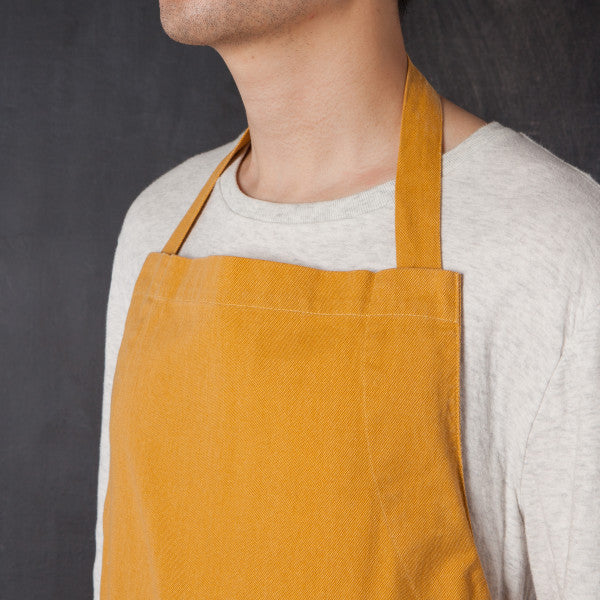 close-up of person wearing apron.