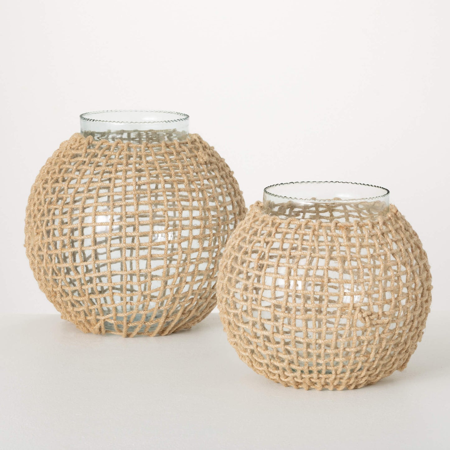 2 round glass vases with very short but wide neck openings wrapped in woven seagrass.