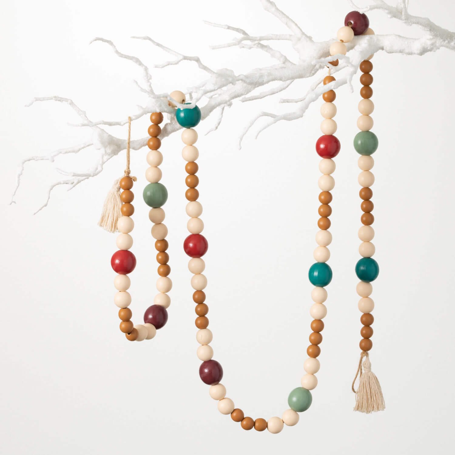 wood bead garland with cream, mustard, blues and green beads and tassels on each end.