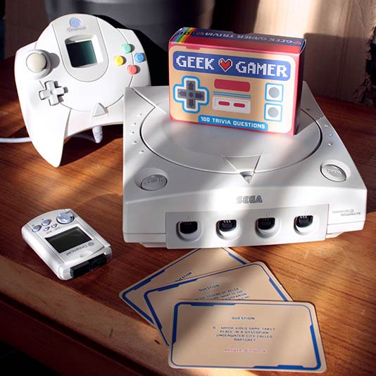 the geek gamer trivia package displayed with a video game console on a table in the living room