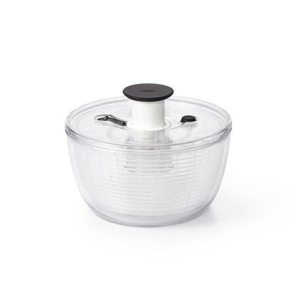 clear salad spinner with colander insert and lid with push button.