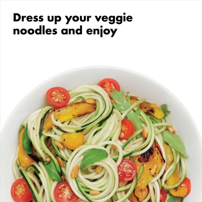 plate of zucchini noodles, tomatoes, and yellow peppers with text "dress up your veggie noodles and enjoy".