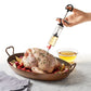 hand injecting liquid into whole chicken.
