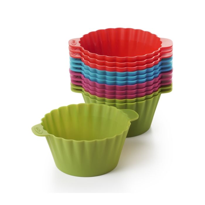 stack of baking cups with a green one set to the side.