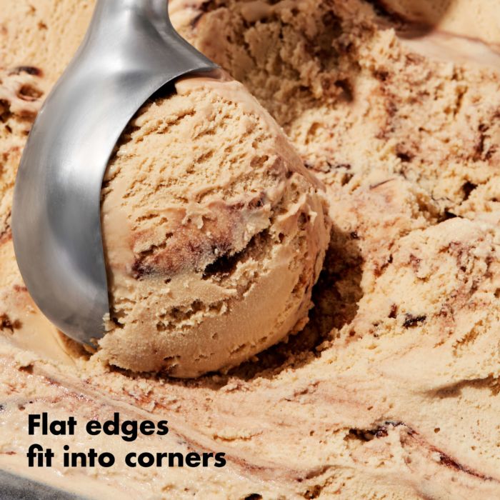 close-up of scoop scooping chocolate ice cream with text "flat edges fit into corners".
