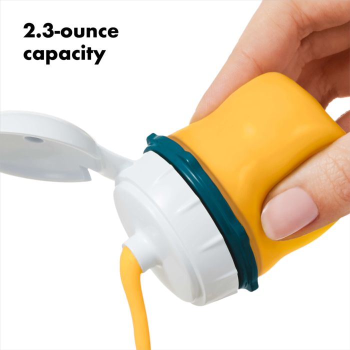 hand squeezing mustard out of silicone bottle with text "2.3 ounce capacity.