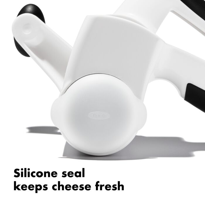 close-up of grater handle with text "silicone seal keeps cheese fresh".