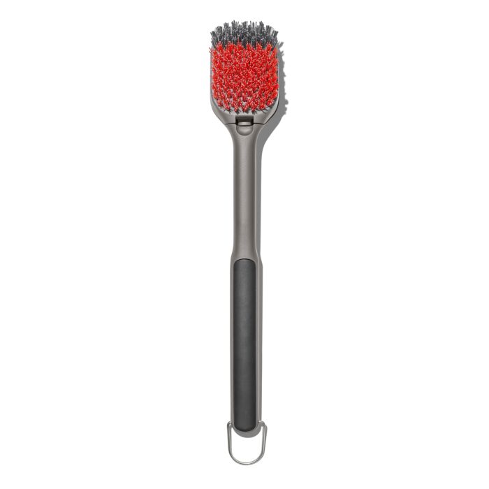 grill cleaning brush with red and grey bristles and grey and black handle.