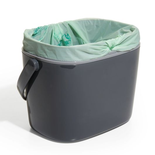 compost bucket with lid off and compost bag inside.