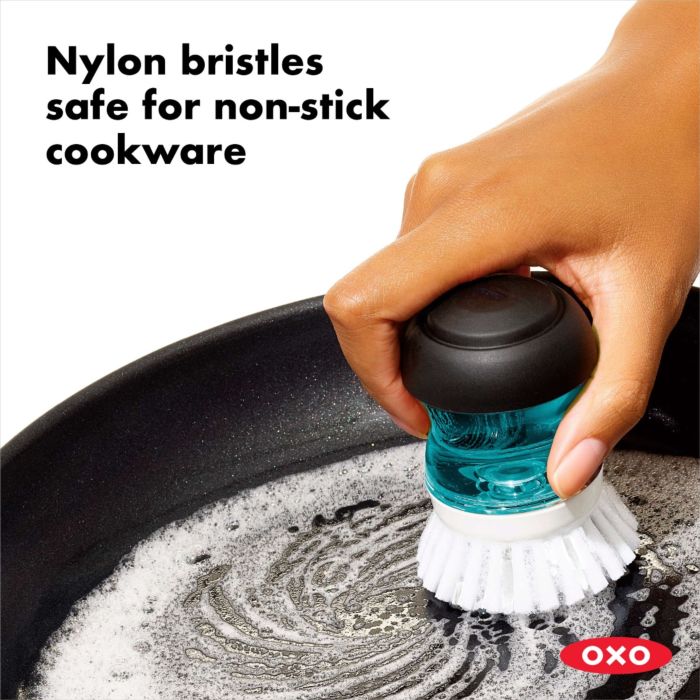 hand scrubbing pan with brush and text "nylon bristles safe for non-stick cookware".
