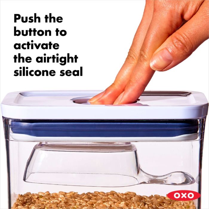 hand pushing button on container lid with text "push the button to activate the airtight silicone seal".